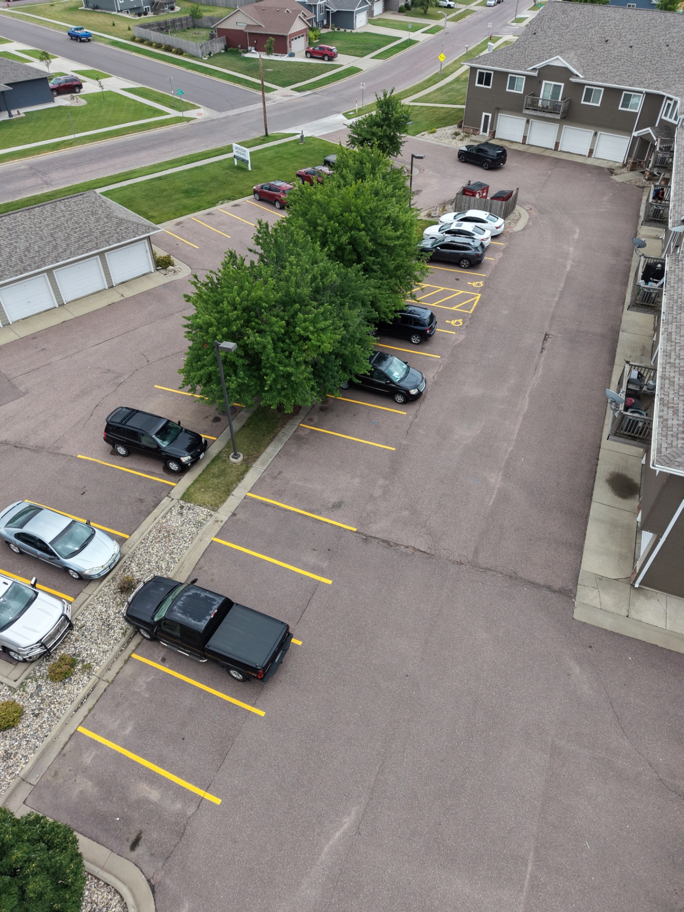 Aerial drone view of the same Sioux Falls parking lot with crisp new yellow striping and ADA stalls by Gold Line Striping