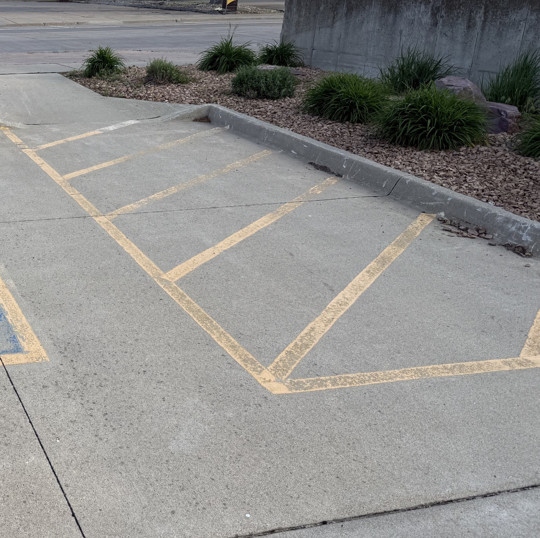 Faded parking lot striping before Gold Line Striping repainted it