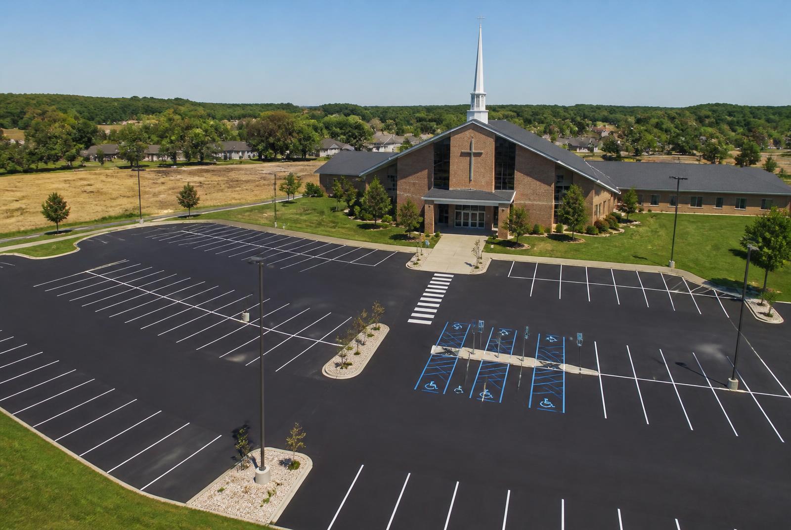 Freshly striped church parking lot in Sioux Falls, South Dakota with white stalls, blue ADA stalls, and a painted crosswalk to the entrance
